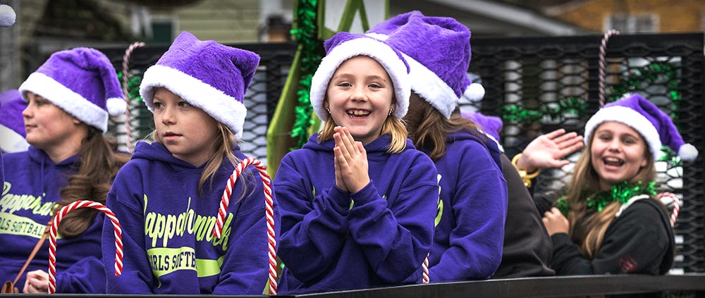 Photos of softball team on float in 2023 Parade